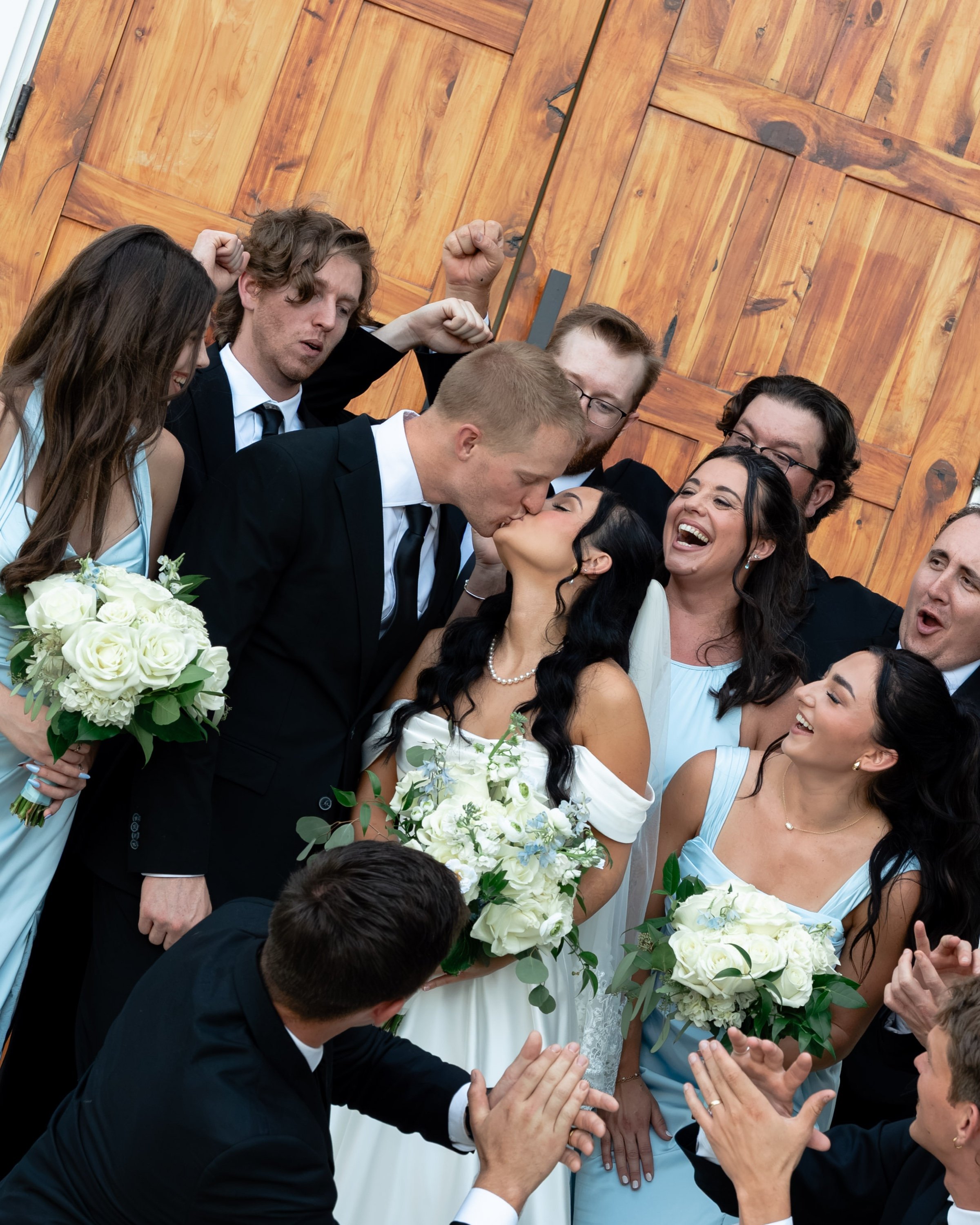 Wedding party cheering with the newlyweds