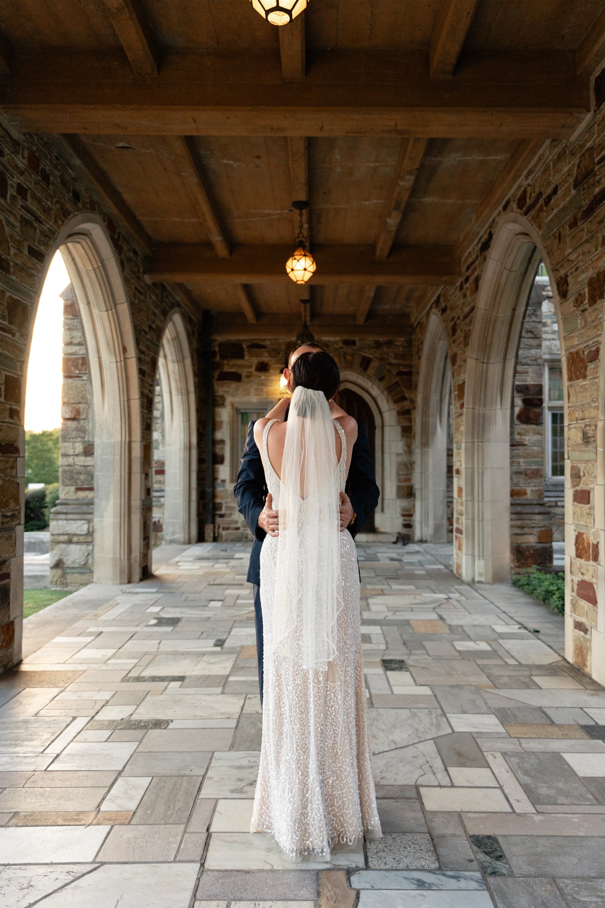 Haleigh and Matt walking through the cloister at Idlewild in Midtown Memphis on their wedding day