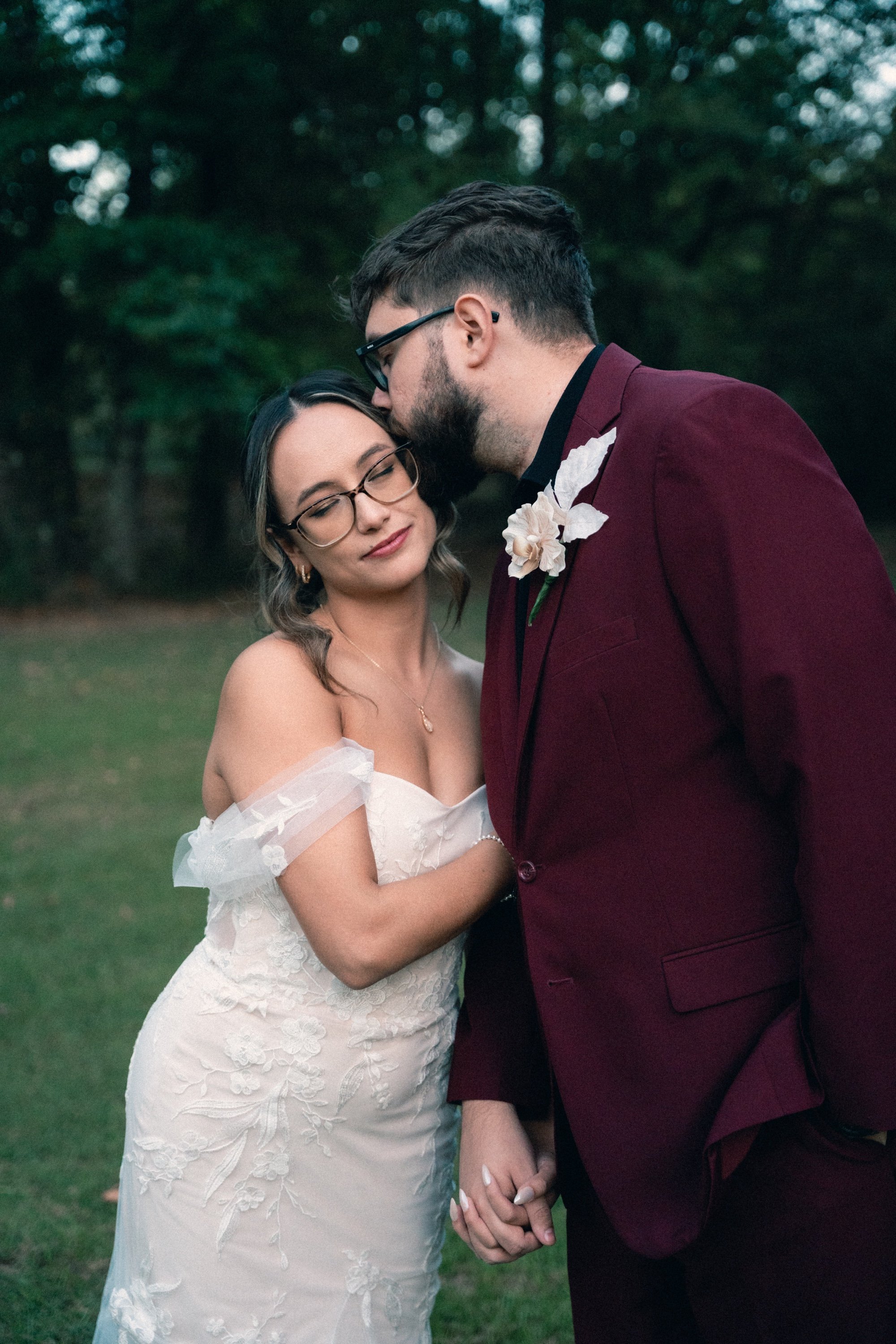 Bride and groom kissing at dusk
